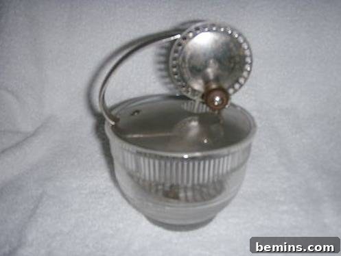 A metal and glass device that holds a substance while a disk rolls on the top, used for beating eggs.