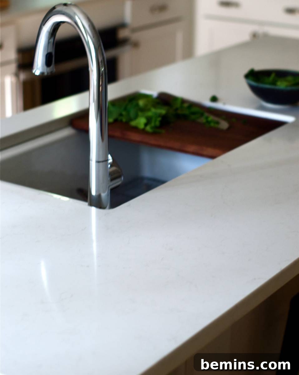 A sink basin sits in a light colored counter.