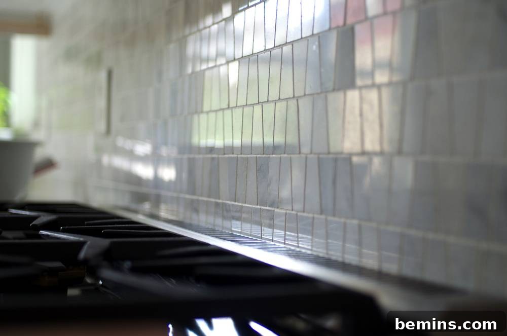 White tiles line a wall in horizontal rows.