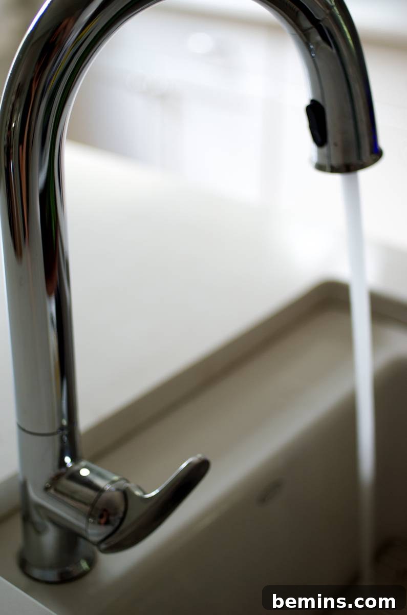Water is running out from a shiny sink.