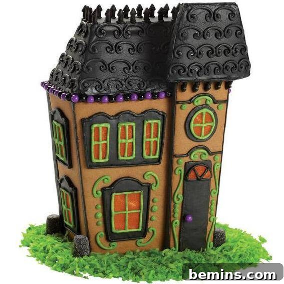 Gingerbread haunted house with black roof and green frosting grass.