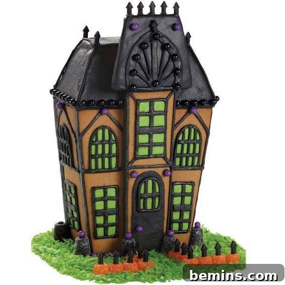 A gingerbread spooky house with a black roof and a face on the attic, green windows and grass around the bottom.
