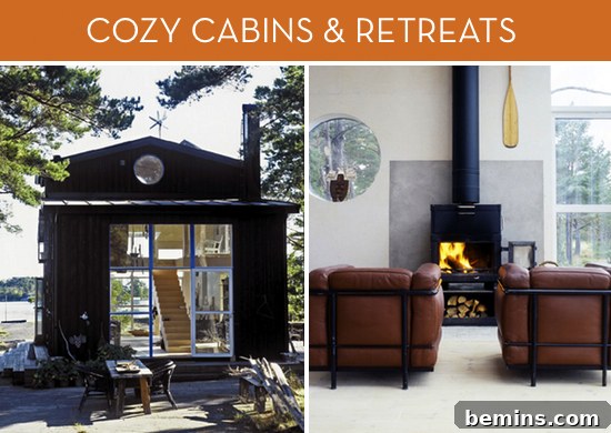 A dark cabin with a large glass front and a wooden stairway inside, two leather chairs in front of an antique fireplace and a oar on the wall.