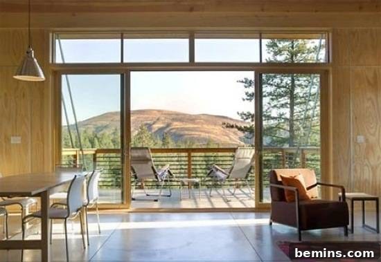 Sliding doors are leading from a living area to an outside deck.
