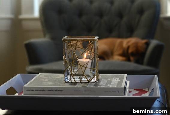 DIY Holiday Votive Candles with Hot Glue Designs 8 A votive candle resting on a stack of books demonstrating the simple elegance of the candle holder.