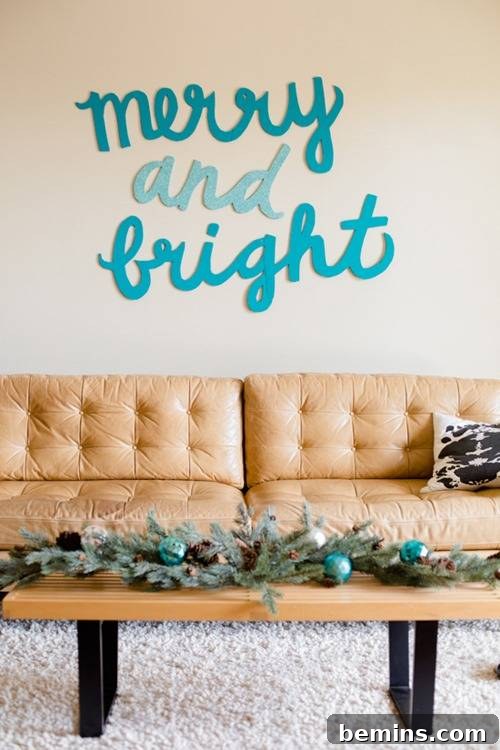 The words "merry and bright" are written in blue, displayed as festive wall decor behind a tan couch, enhancing the holiday ambiance.