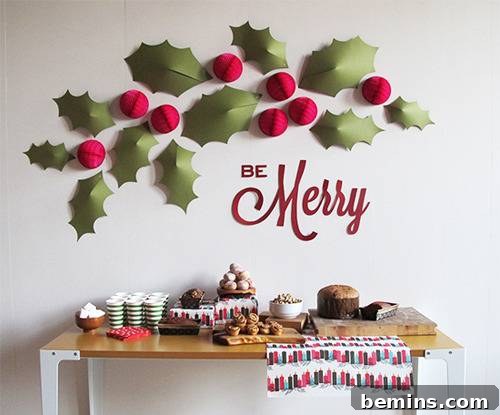 A wall decorated with paper holly leaves and cherries, complemented by a table adorned with festive food items, creating a holiday-themed setting.