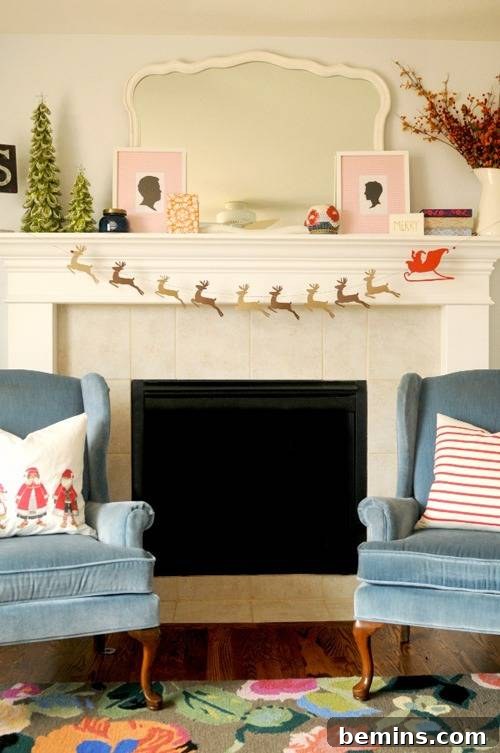 A festive Santa and reindeer garland adorning a fireplace, creating a cozy Christmas atmosphere near two armchairs.
