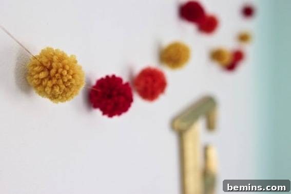 10 Ways to Add Pom-Pom Power to Your Decor & Crafts 6 Colorful pom-pom garland strung on a string, a festive decoration for any occasion.