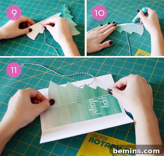 DIY Christmas Tree Card Tutorial Free Template 6 A person folding a card on a green gridded material, demonstrating the careful assembly of the DIY Christmas card.