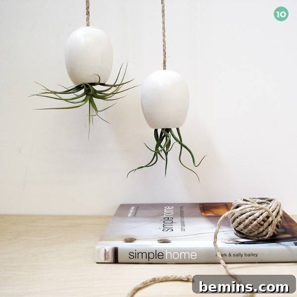 Flowers are growing upside down in white hanging planters