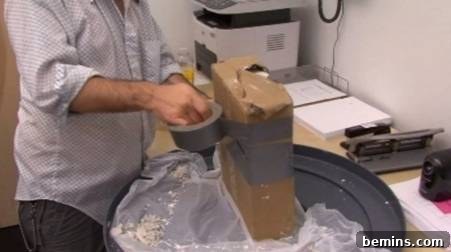 How to Craft a Realistic Replica Hand 8 Man using a roll of duct tape to wrap around and close a mold.