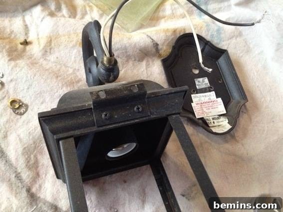 The Black lantern with the glass taken out and no light bulb sits on a towel. Shows the lantern frame without glass.