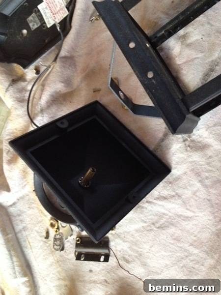 Metal lantern separated into different pieces. Shows all components separated.