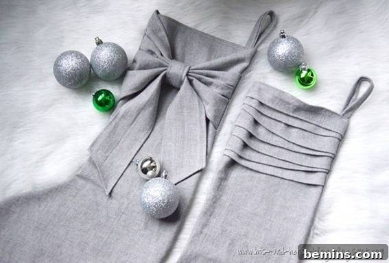 Silver Christmas stockings with gracefully ruffled edges, adorned with delicate Christmas ornaments, exuding an air of sophisticated elegance.