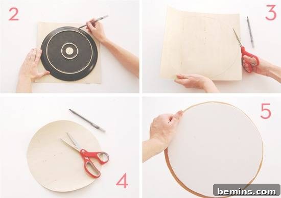 A round dish is used to trace a circle on a construction paper, which is then cut with a pair of red-handled scissors.