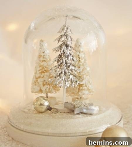 A bell jar filled with miniature Christmas trees and festive figurines, creating a charming Christmas scene.
