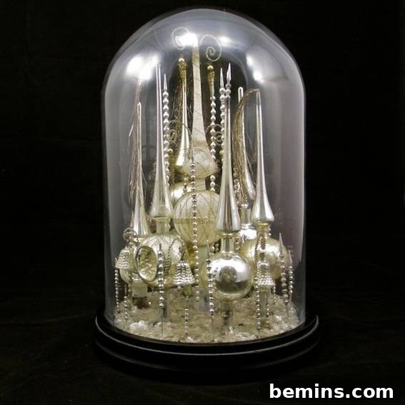 Vintage Christmas tree toppers displayed under a bell jar, creating a unique and nostalgic Christmas decoration.