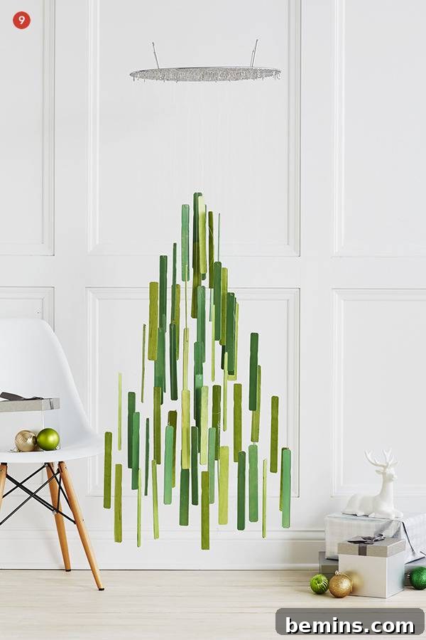 Creative Christmas: 10 Unique Tabletop Tree Alternatives 11 A mobile is made of long green vertical strips with the overall shape being a Christmas tree.