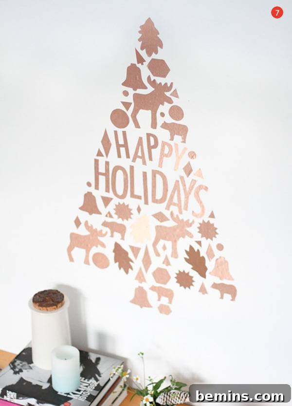 Creative Christmas: 10 Unique Tabletop Tree Alternatives 9 Vinyl Christmas tree with the words "Happy Holidays" with moose, bells, bear, leaves, and bells creating the Christmas tree pattern.