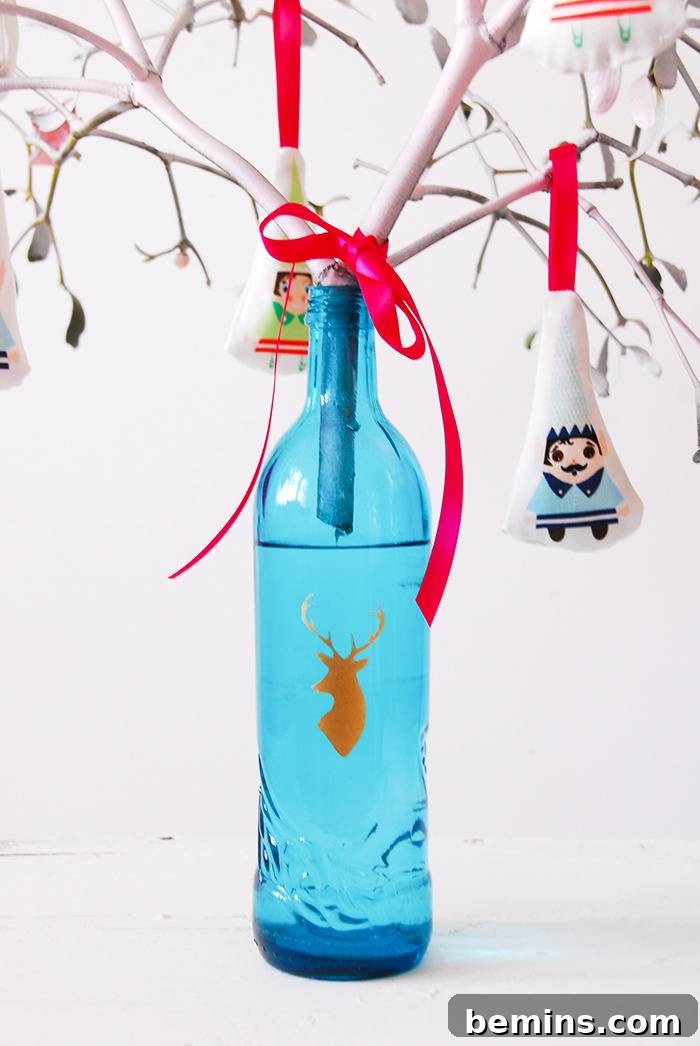 A blue bottle with a deer's head graphic on it has branches sticking out of it.