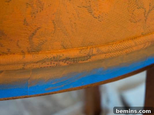 Close-up showing paint pooling in the trim crevices of the Victorian chair.