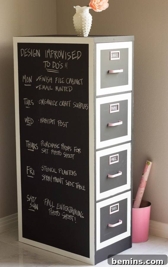 Tips for Radically Revamping Your Filing Cabinet 4 A black and white filing cabinet in the corner of a room near a pink container, demonstrating a chalkboard paint idea.