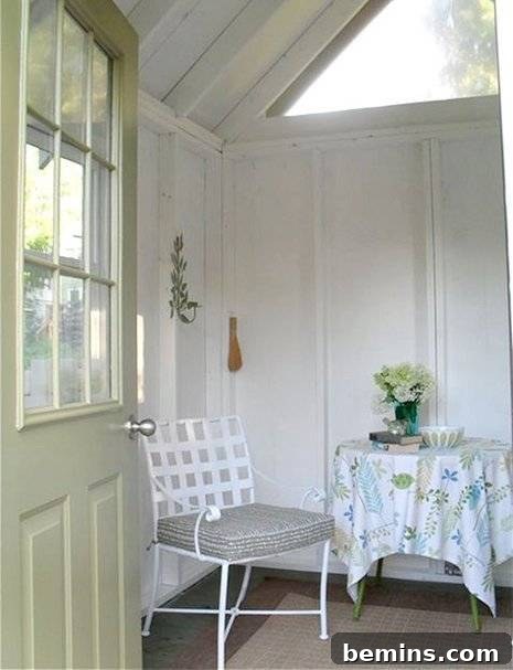 Eye Candy: 11 Tiny Homes That Will Steal Your Heart 14 Tiny home interior with chair, side table, and flower vase