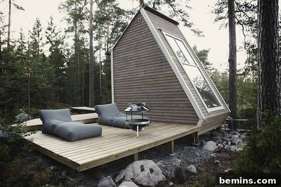 Eye Candy: 11 Tiny Homes That Will Steal Your Heart 21 Cushioned chairs and fire pit on a deck near a cabin