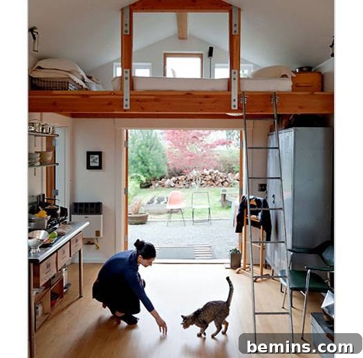 Eye Candy: 11 Tiny Homes That Will Steal Your Heart 8 Woman playing with a cat in a garage-turned-home