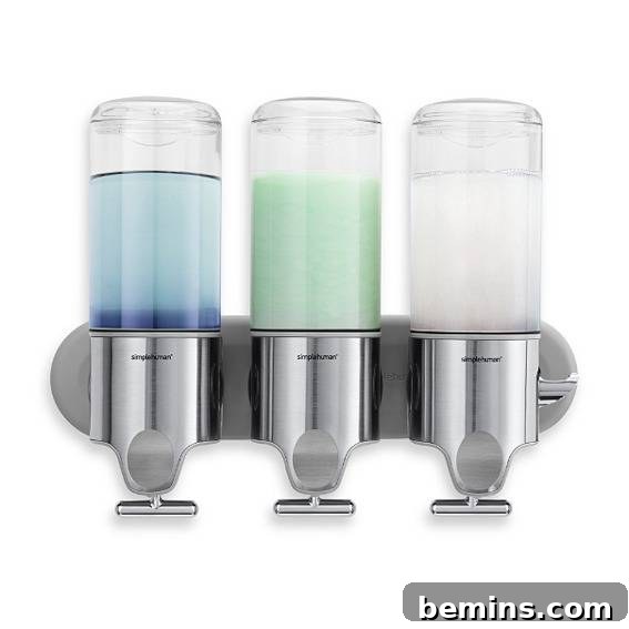 Three soap dispensers having different color liquid soap in them, showcasing wall-mounted solutions.