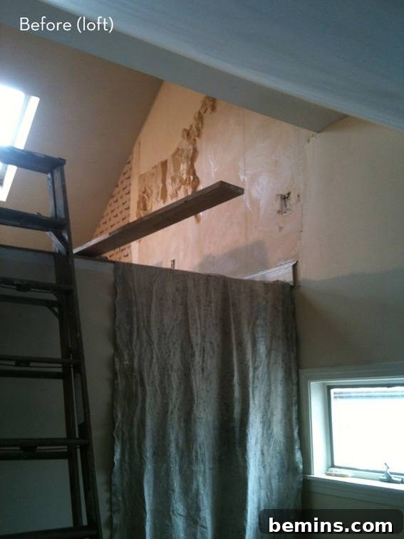 The 'before' image of the loft in the coastal cottage, showing its original condition before the renovation.