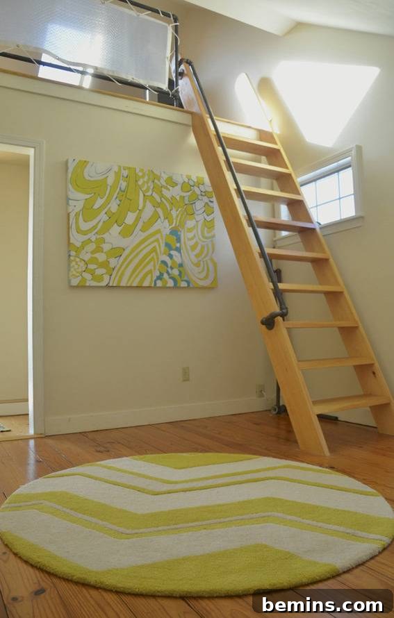 The ladder leading to the loft in the renovated coastal cottage, showcasing a unique and functional design element.