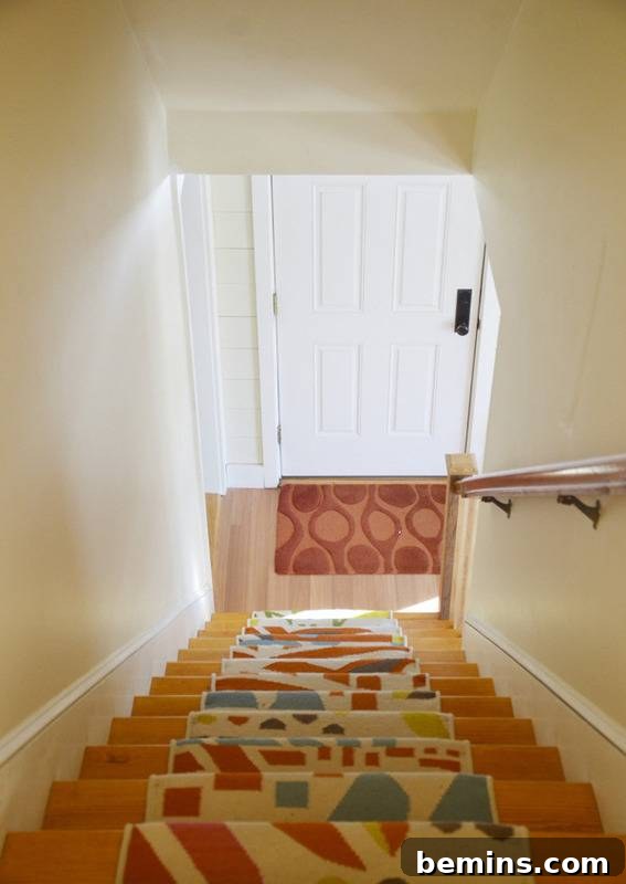 The colorful stair runner in the renovated coastal cottage, adding a vibrant and playful touch.