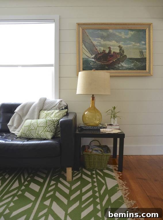 Another view of the renovated living room, highlighting the coastal-inspired decor and comfortable furnishings.