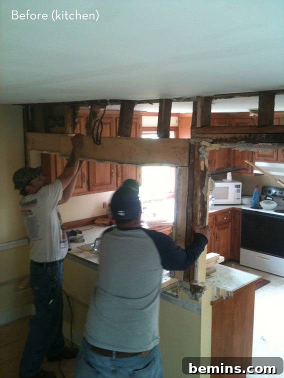 The 'before' image of the kitchen in the coastal cottage, showing the original state prior to the renovation.