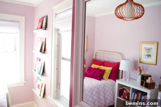 A Girl's Room with Pink Walls and a Cozy Bed Blanket