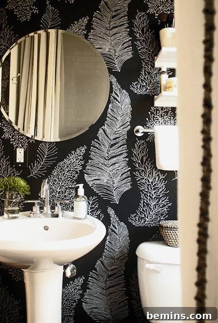 Black wall with leaf painting, kitchen sink, and mirror for a colorful entry