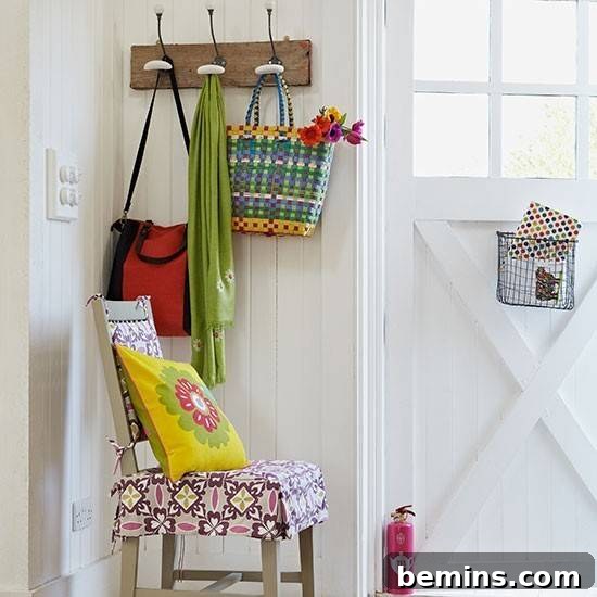 Home entryway with a multicolored chair and a coat rack