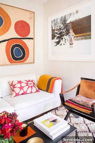 Living room with sofa, chairs, and cushions featuring black and white art