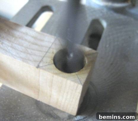 Drilling a hole in a wooden block using a power drill