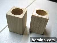 Close-up of a completed test tube vase with a smooth wooden base