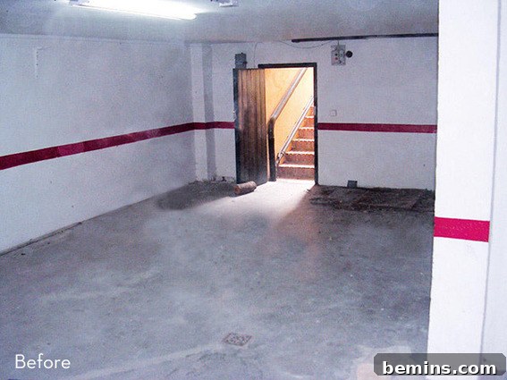 An empty garage with white walls and cement floor.