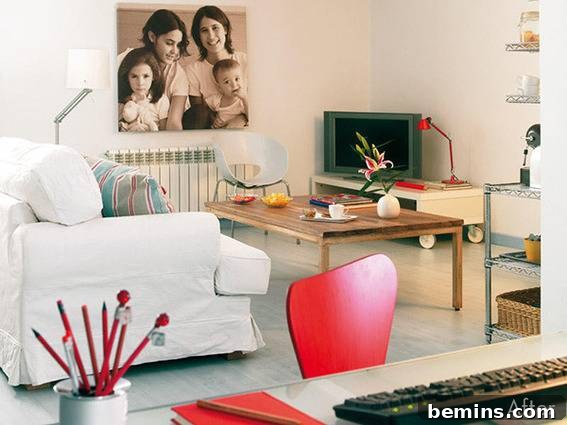 Living room with a large coffee table, a big family portrait, and a white couch.