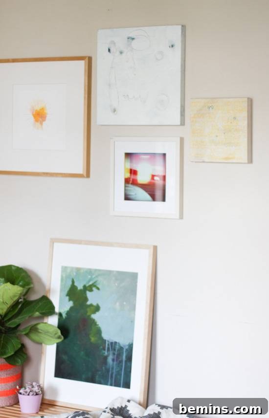"Entryway is with plant pot and wall frames."