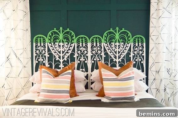 A bed with a blue and white decorative headboard has many pillows in front of it.