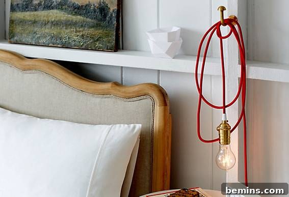 An Edison bulb hanging next to the bed over a nightstand.