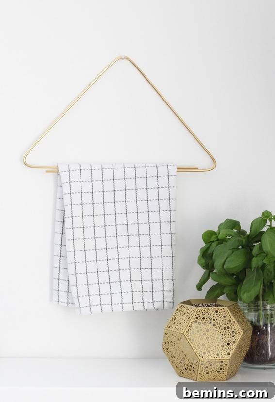 A blue and white towel hangs on a triangular hanger.