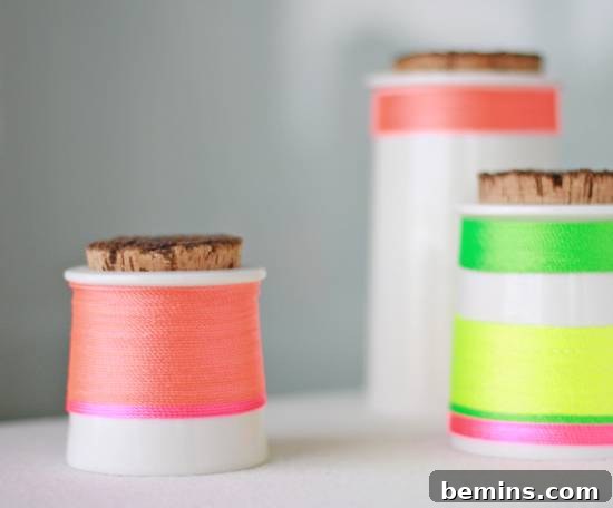 Rolls of thread are sitting on a white surface.