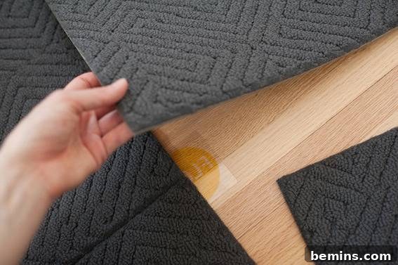 Scandinavian Sanctuary: Bedroom and Bath Transformation 15 Wooden floor covered with blue carpets, showing the FLOR rug installation.